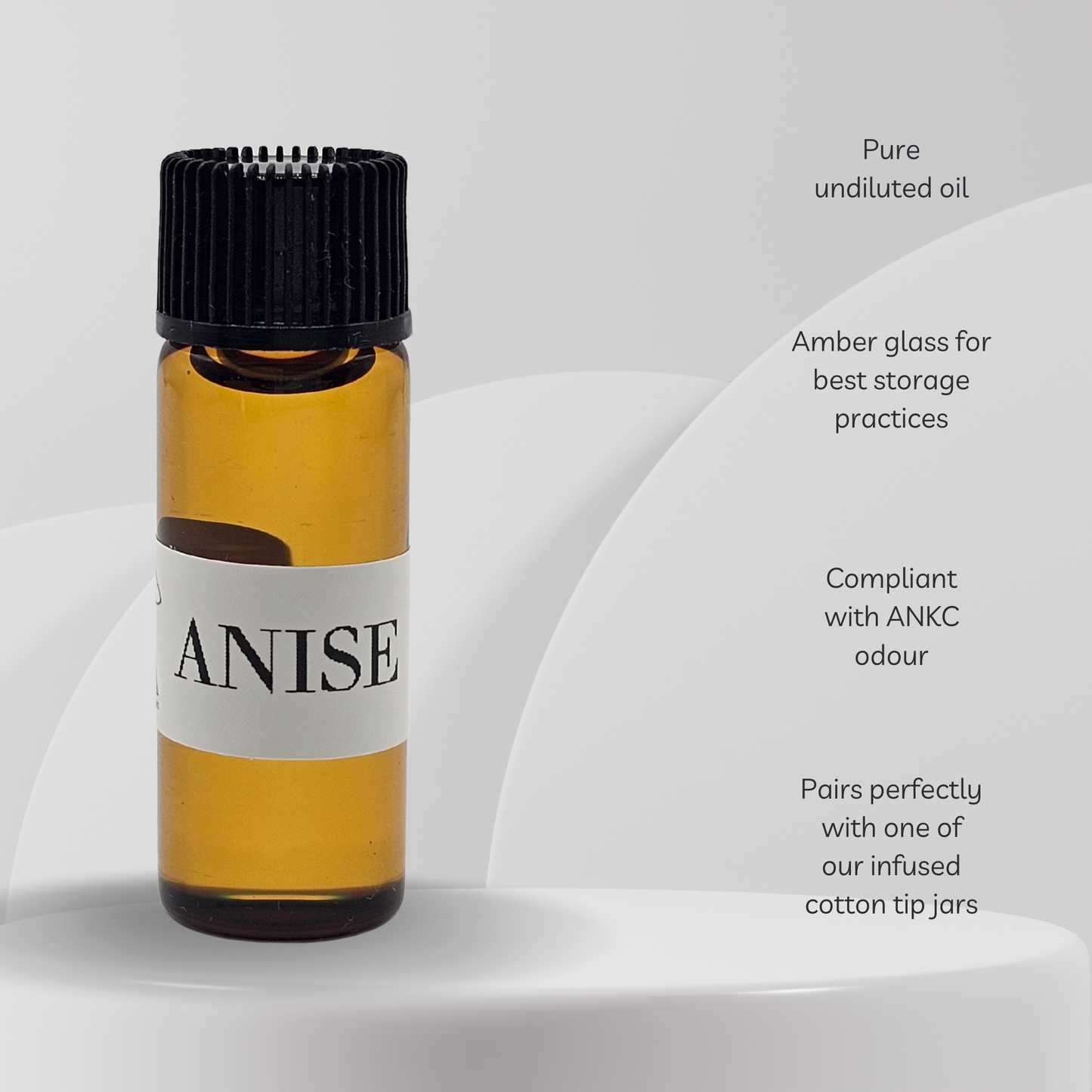 Anise essential oil bottle with a black cap on a white background