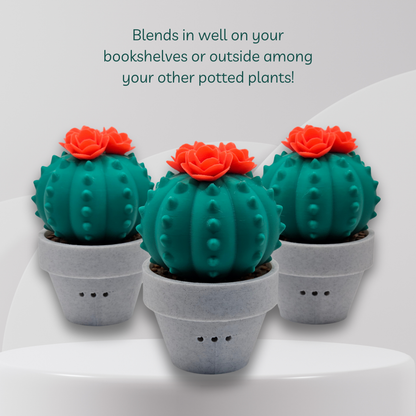 Three green artificial cactus in gray pots on a white surface with text about their use.