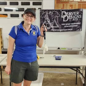 Person holding an ultimate scent travel set in an indoor setting with a Denver Designs banner in the background.