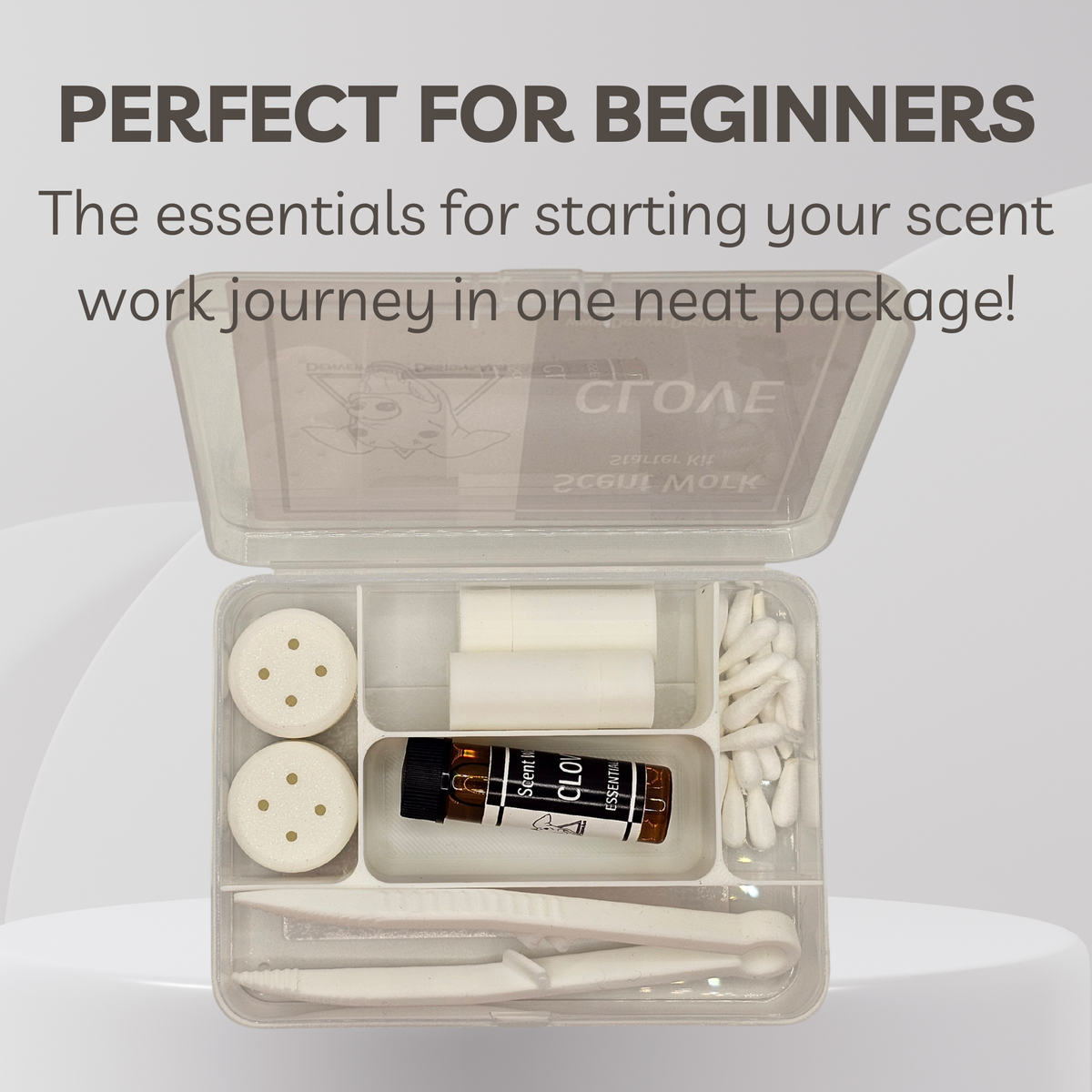 An open clear plastic compartment kit with white tools and a small amber bottle labeled 'Scent Work' and 'CLOVE 5 ml', shown on a light gray background with promotional text at the top.