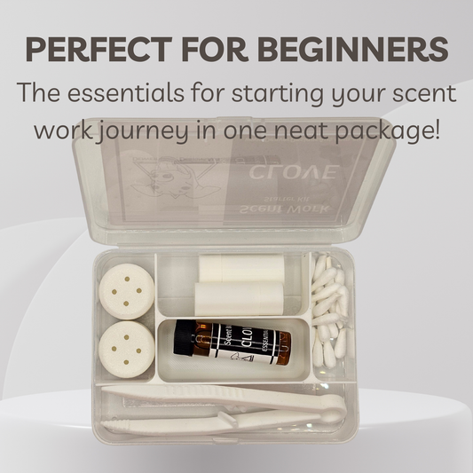 An open clear plastic compartment kit with white tools and a small amber bottle labeled 'Scent Work' and 'CLOVE 5 ml', shown on a light gray background with promotional text at the top.
