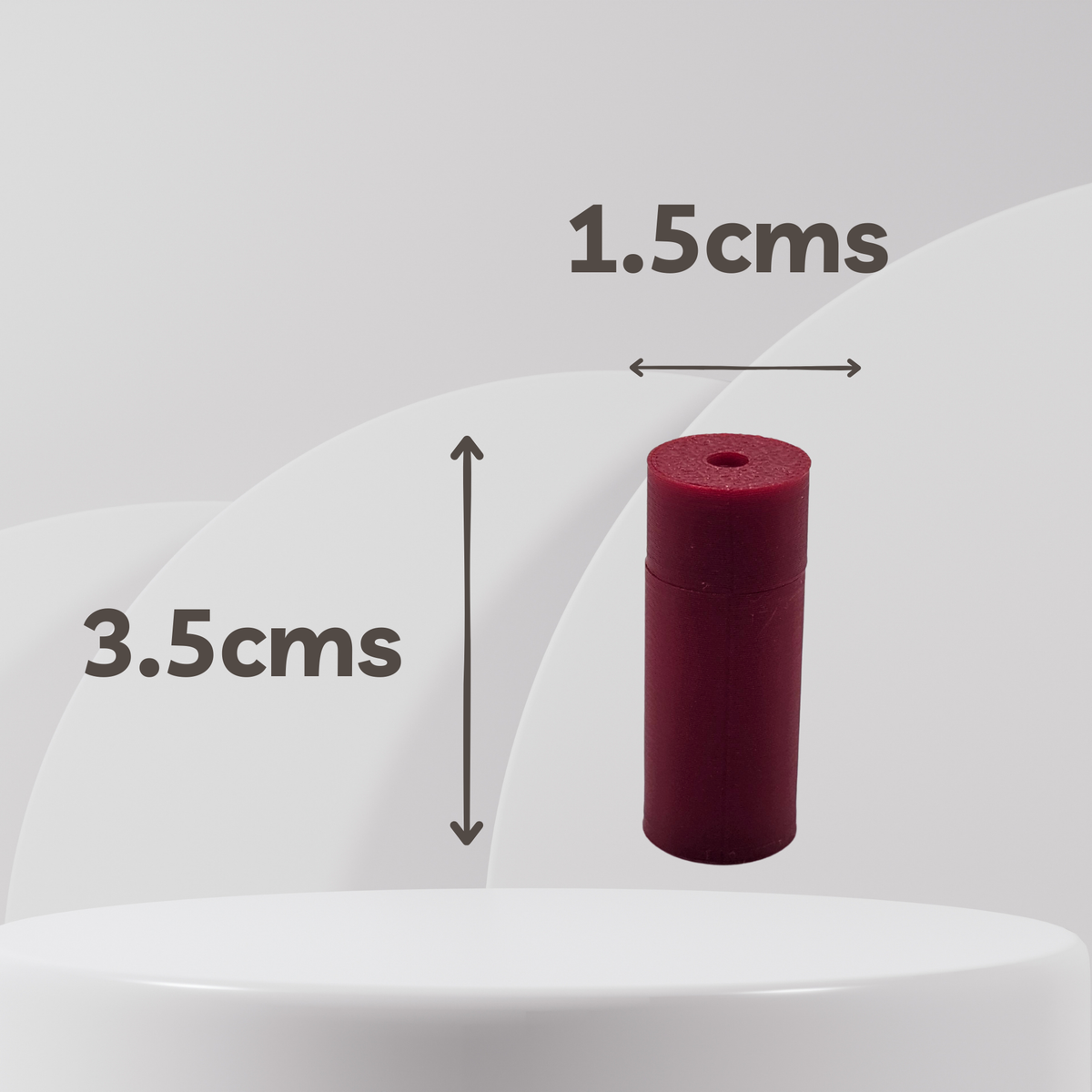 A small cylindrical red scent vessel shown on a light gray background with overlaid dimension arrows and text reading 1.5cms wide and 3.
