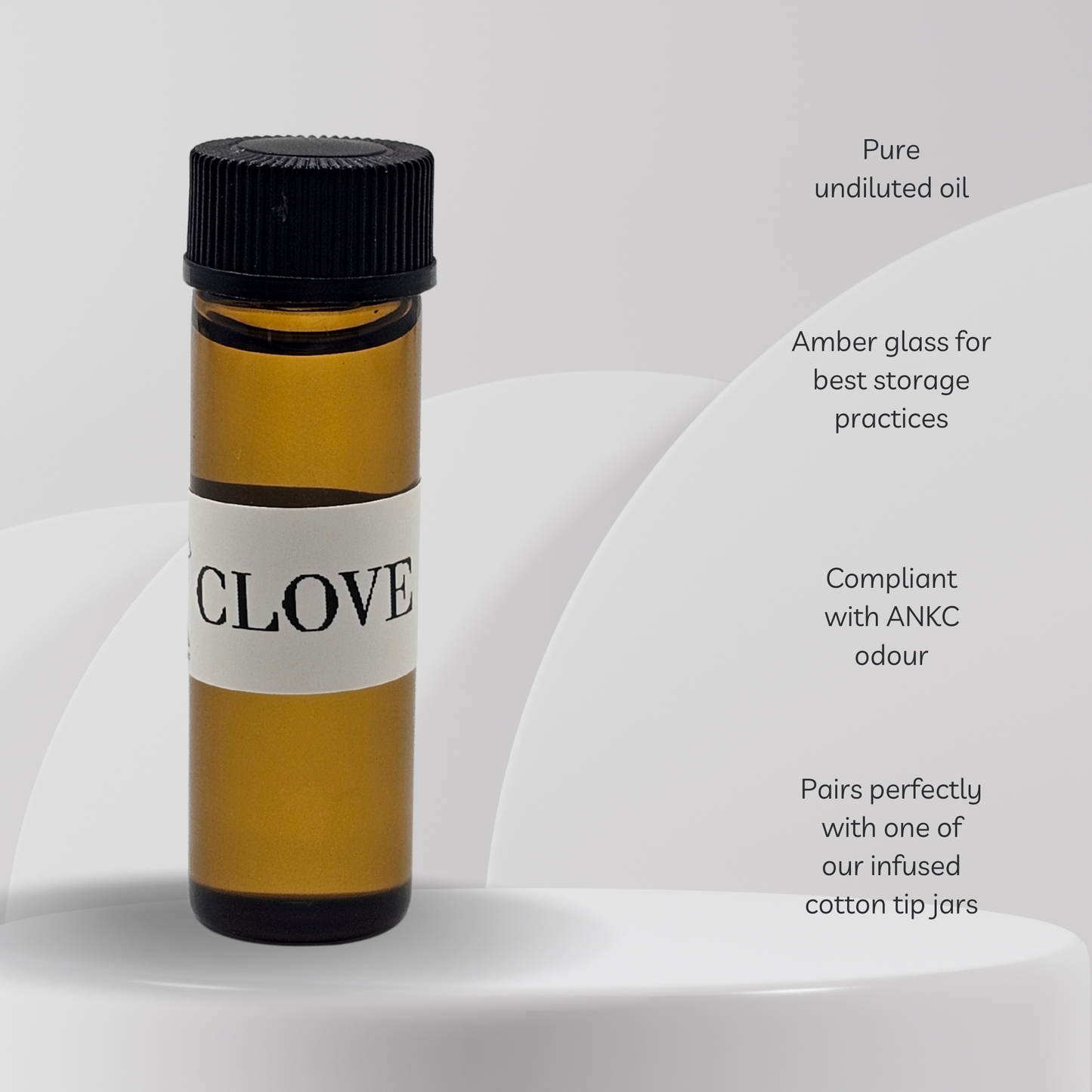 Amber glass bottle labeled 'Clove' with black cap on a white background