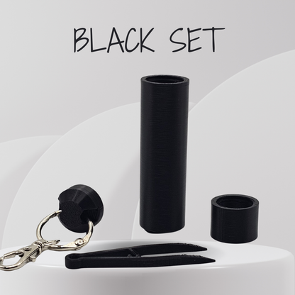 Black set including a clip, keychain, and cylindrical container on a white background.