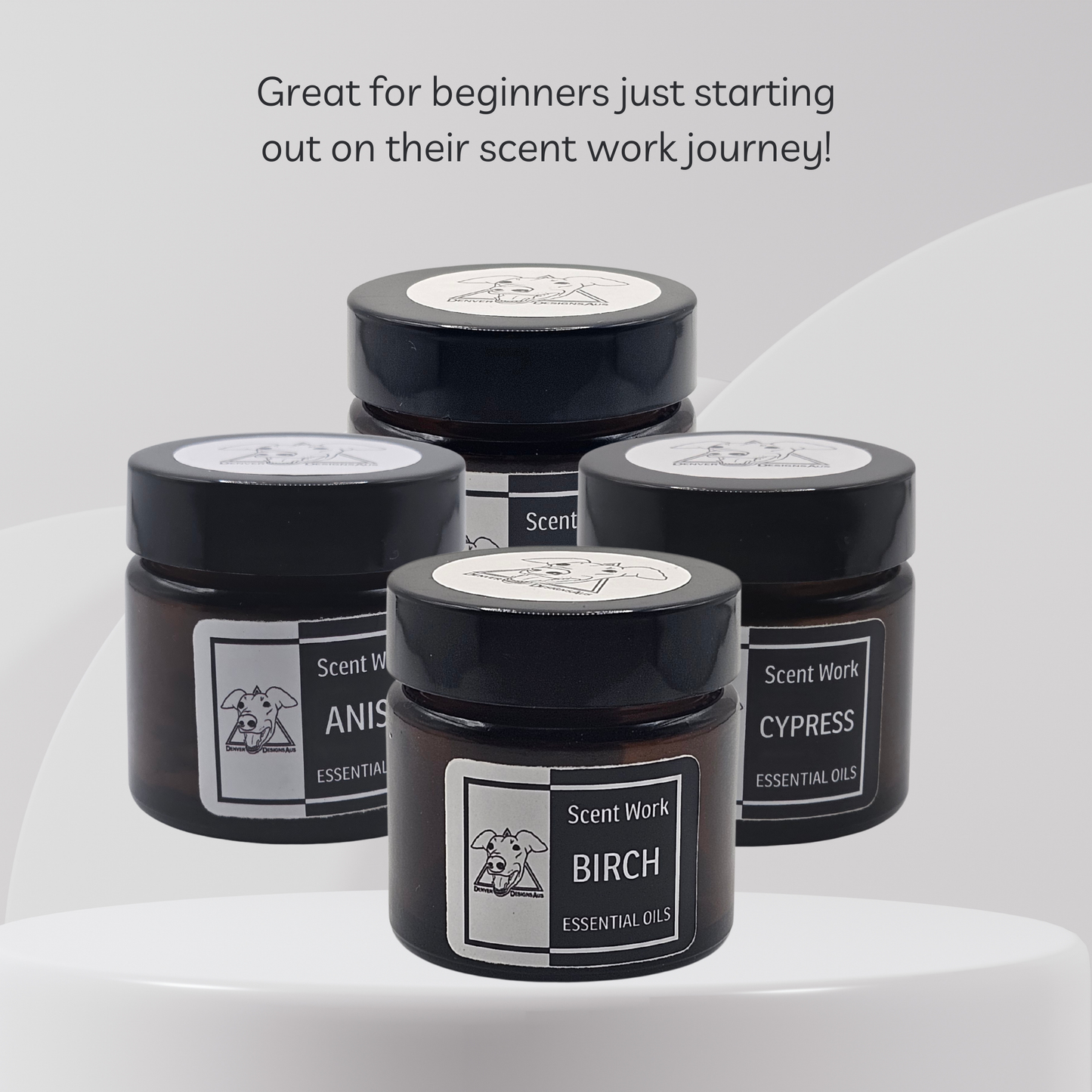 Four black jars with labels on a white background, featuring essential oils.