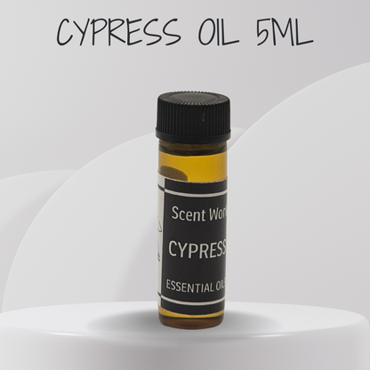 Bottle of Cypress essential oil with a black cap on a white background