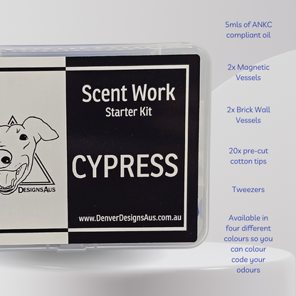 Scent Work Starter Kit in a clear plastic case with a black and white label reading 'CYPRESS' and 'Denver Designs Aus' branding. Blue text on the right lists included items: 5mls of ANKC compliant oil, 2x Magnetic Vessels, 2x Brick Wall Vessels, 20x pre-cut cotton tips, and Tweezers, noting availability in four different colours.