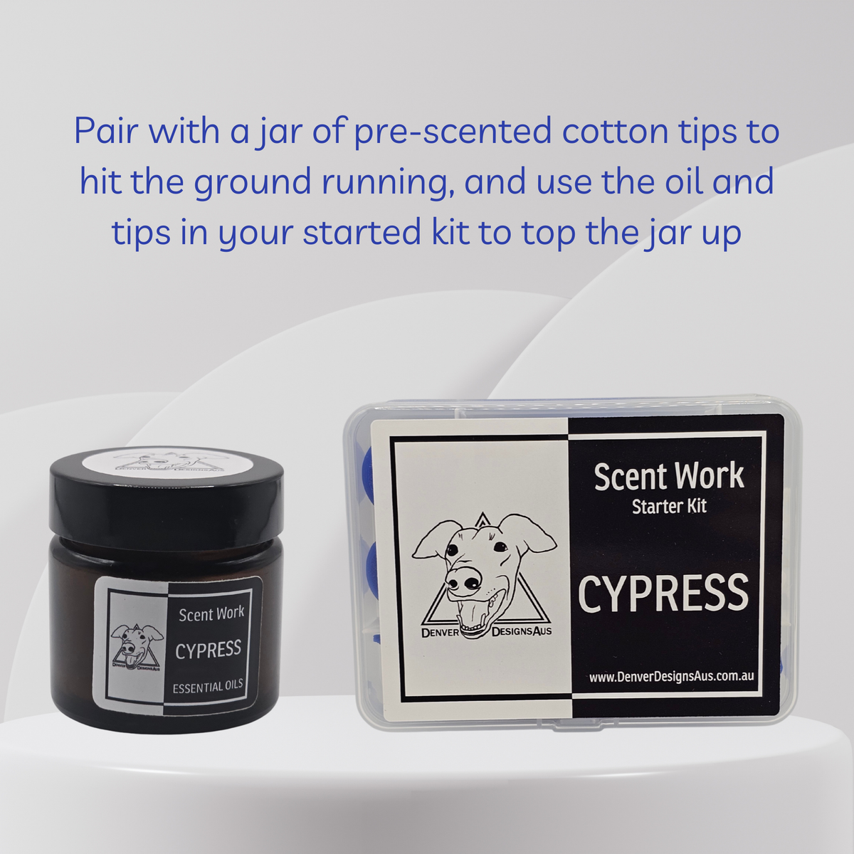 Scent Work Starter Kit in Cypress scent, showing a small black jar of essential oil next to a clear plastic box containing the starter kit components, with blue text instructions above on a light gray background.