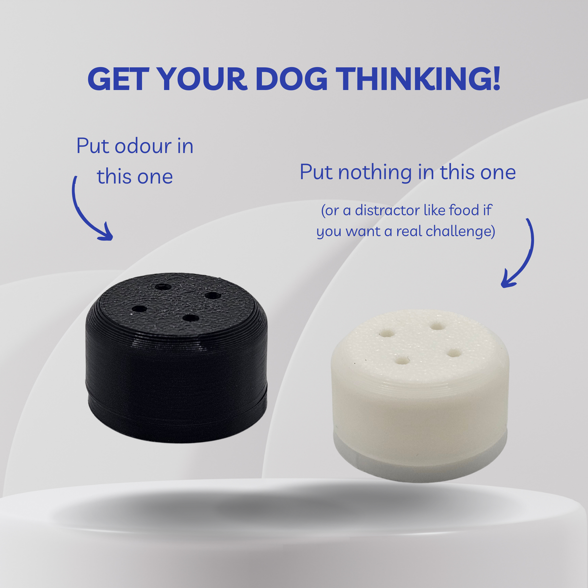 Two cylindrical dog training scent vessels on a light gray background with instructional text. One vessel is black and labeled 'Put odour in this one', and the other is white and labeled 'Put nothing in this one (or a distractor like food if you want a real challenge)'.