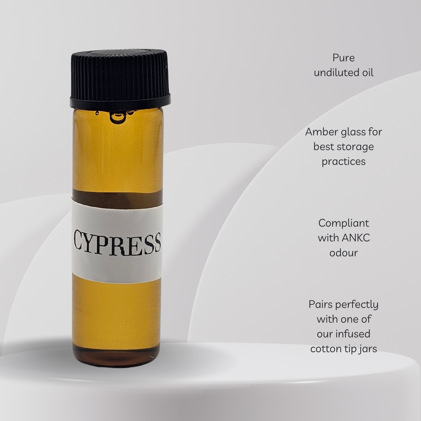 Amber glass bottle labeled 'Cypress' on a white background with text about oil storage.