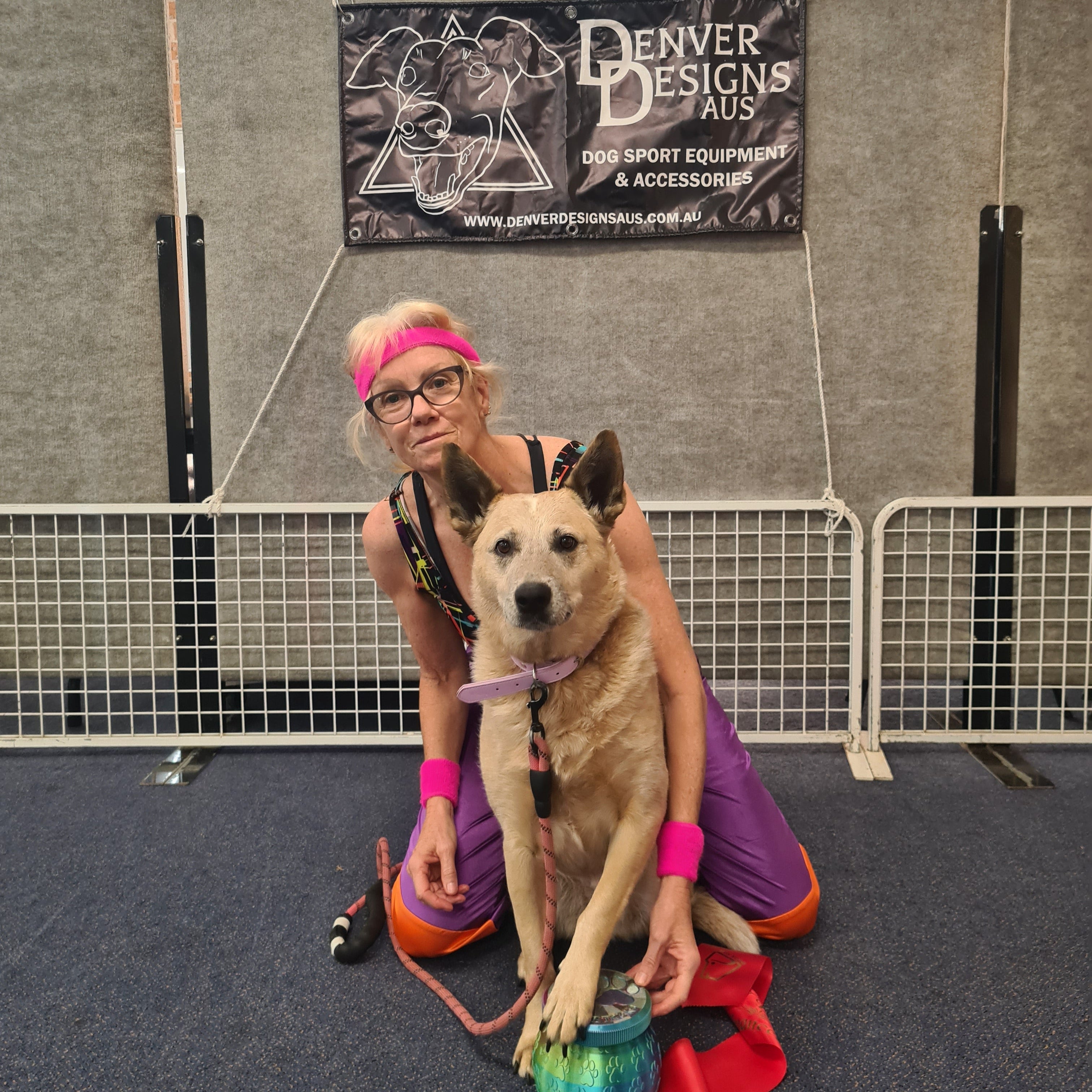 Person and dog standing on a mat with 'Denver Design' branding