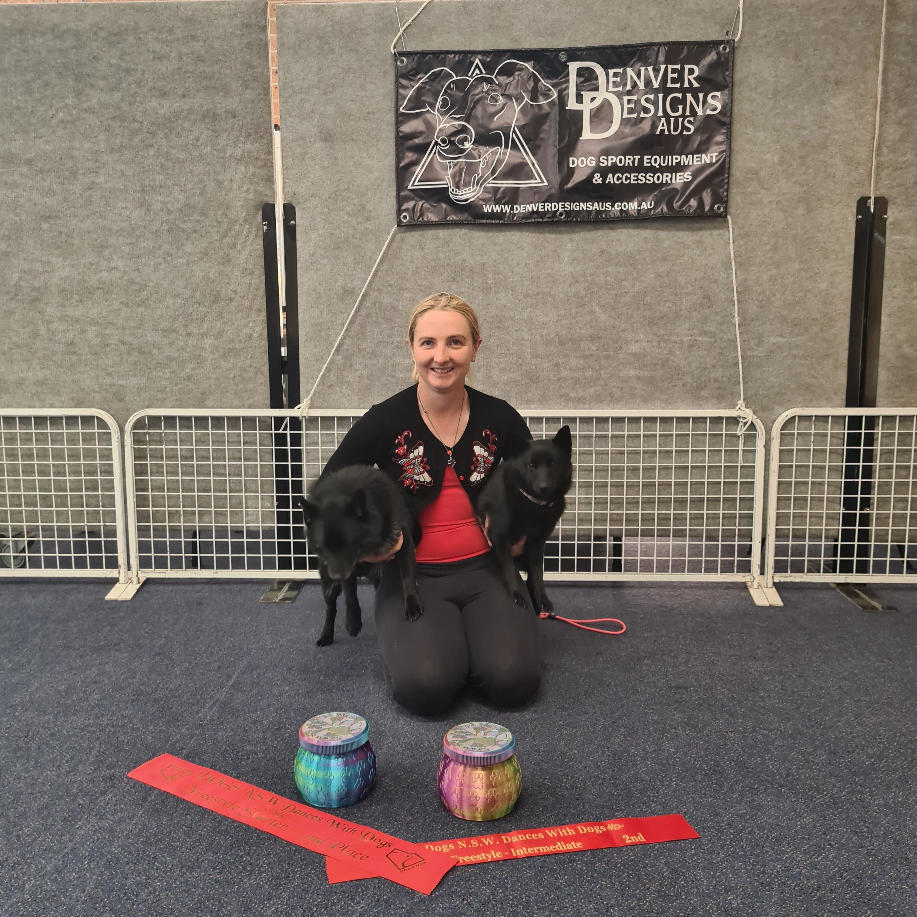 Person with a dog in an indoor setting with various items on the floor.