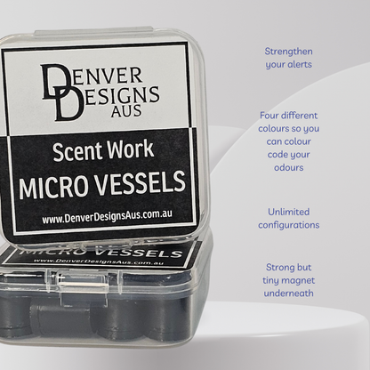 A clear plastic case containing black circular micro vessels, with a large black-and-white label reading 'Denver Designs Aus Scent Work Micro Vessels.' Blue text on the right lists features such as strengthening alerts, four different colors, unlimited configurations, and a strong but tiny magnet underneath.