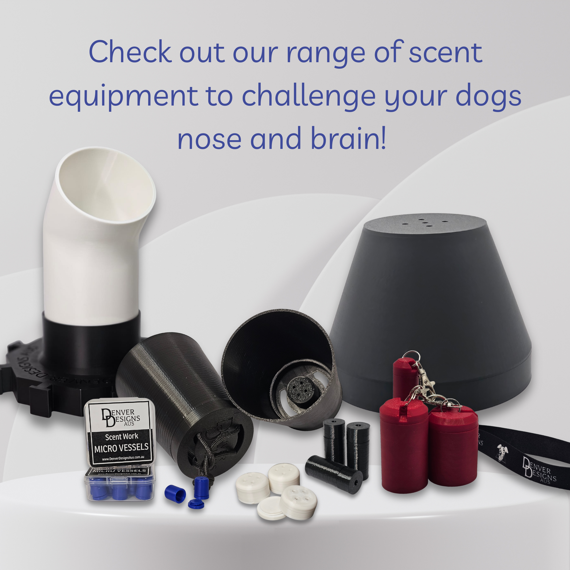 A dog scent training kit displayed on a white surface with a light gray background. The kit includes a black and white plastic scent tube, a black cone-shaped scent dome, a black cylindrical suspended scent cup, red cylindrical scent vessel, white and black micro-vessels, and a small branded box.