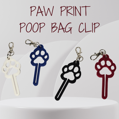 Four paw print shaped poop bag clips in white, blue, black, and red, displayed on a white pedestal with the text 'PAW PRINT POOP BAG CLIP' at the top.
