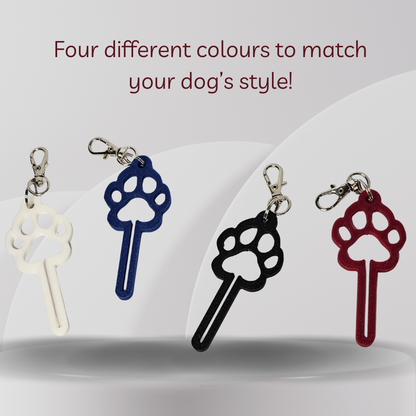 Four dog paw-shaped keychains in white, blue, black, and red, displayed on a light gray background with the text 'Four different colours to match your dog's style!' at the top.