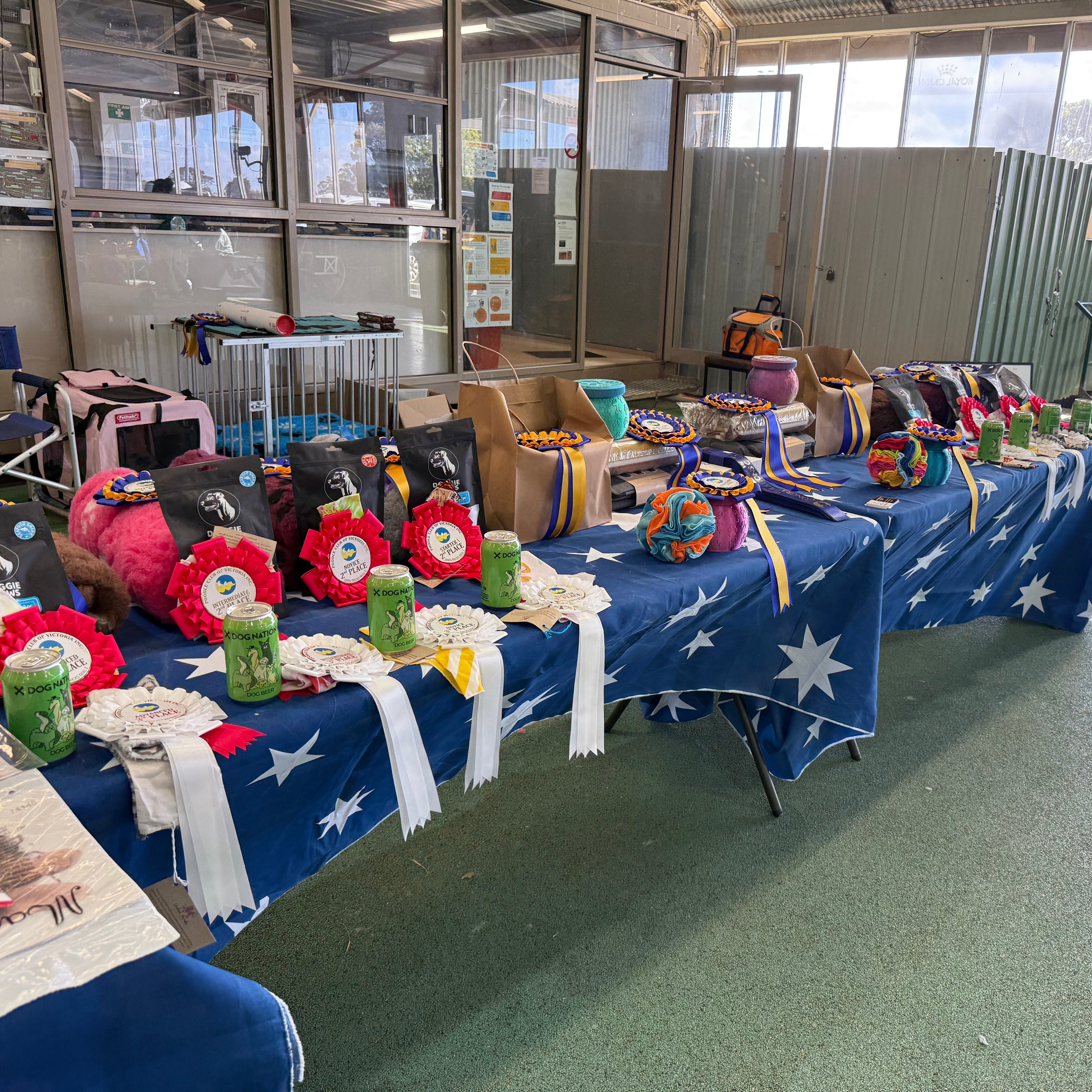 Decorated table with flowers and flags in a room with large windows
