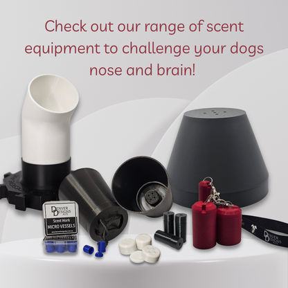 A dog scent training kit displayed on a white surface with a light gray background. The kit includes a black and white scent tube, a black cone-shaped scent dome, a black cylindrical suspended scent vessel, red cylindrical scent bottles, white and black micro-vessel inserts, and a small branded box.