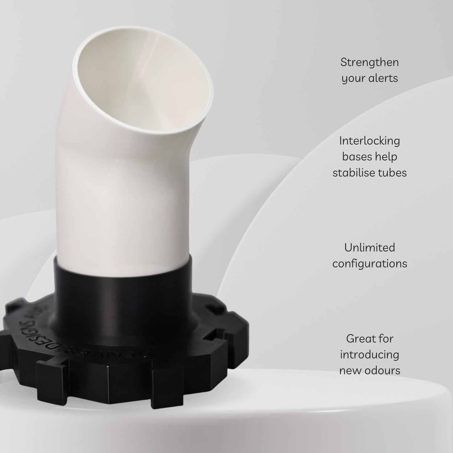 White cylindrical object with black base on a light gray background