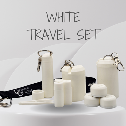 A white travel set displayed on a white surface against a light gray background with the text 'WHITE TRAVEL SET' at the top. The set includes several insulated bottle and cup containers in white, small cylindrical containers, a black branded wrist strap reading 'Denver Designs Aus', and metal keychain clips.