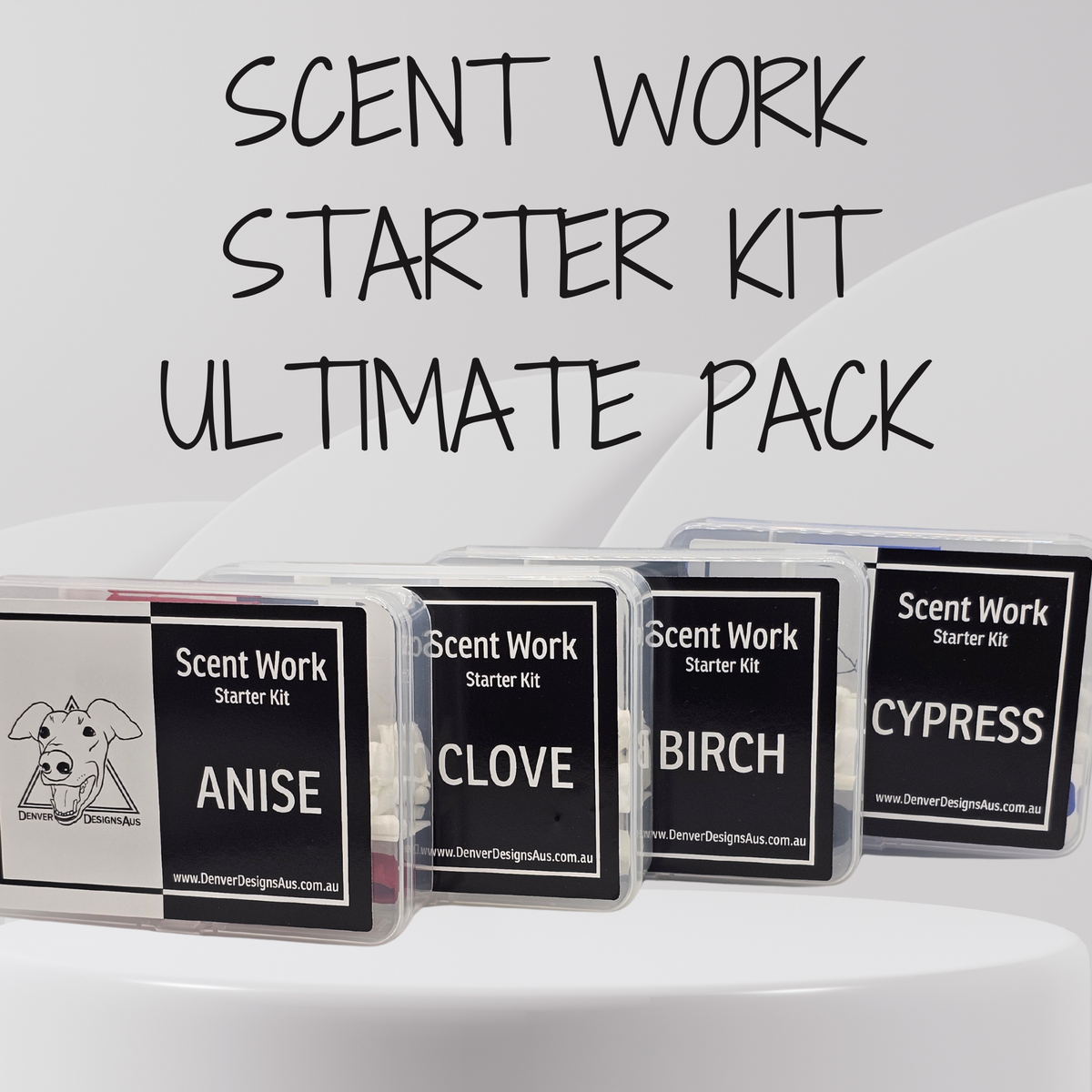 Four small clear plastic boxes labeled Scent Work Starter Kit with scent names Anise, Clove, Birch, and Cypress, arranged in front of large text reading 'SCENT WORK STARTER KIT ULTIMATE PACK' on a light gray background.